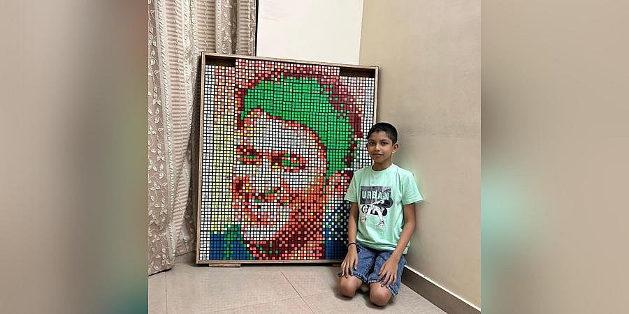 Shresht Prabhu beside his Rubik's cube portrait of Puneeth Rajkumar