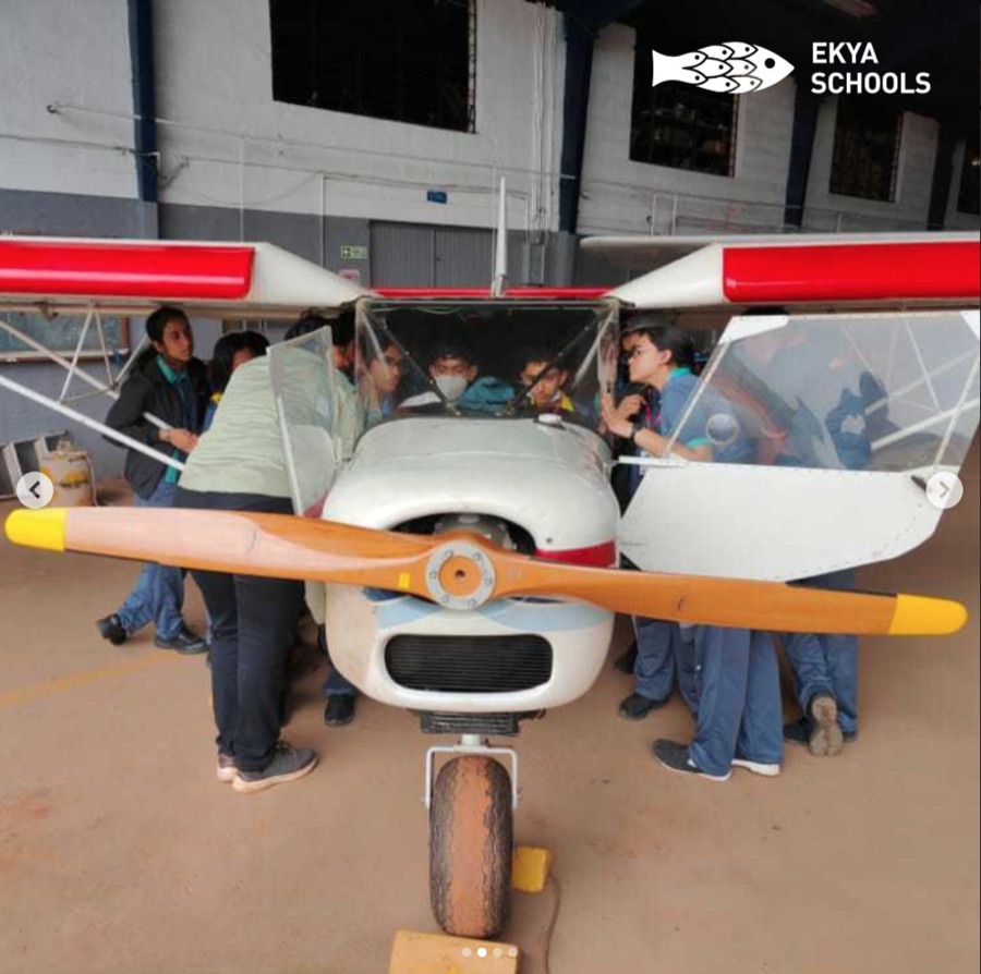 Instagram post, students at an aircraft hangar