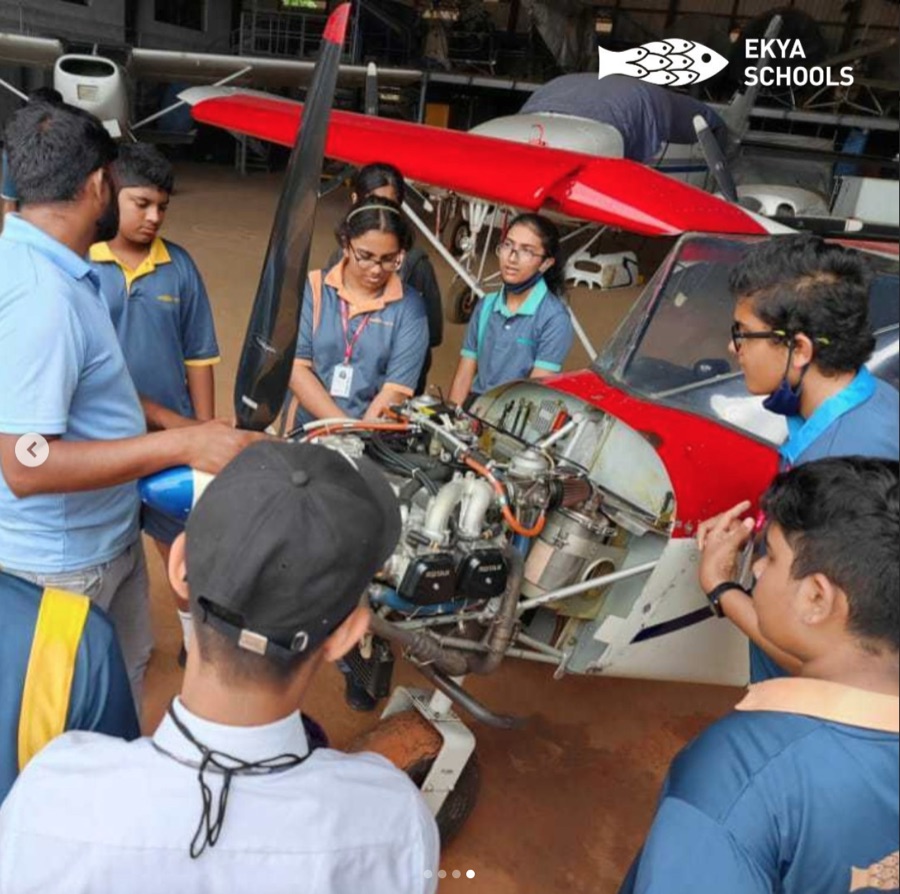 Instagram post, students looking at an aircraft engine