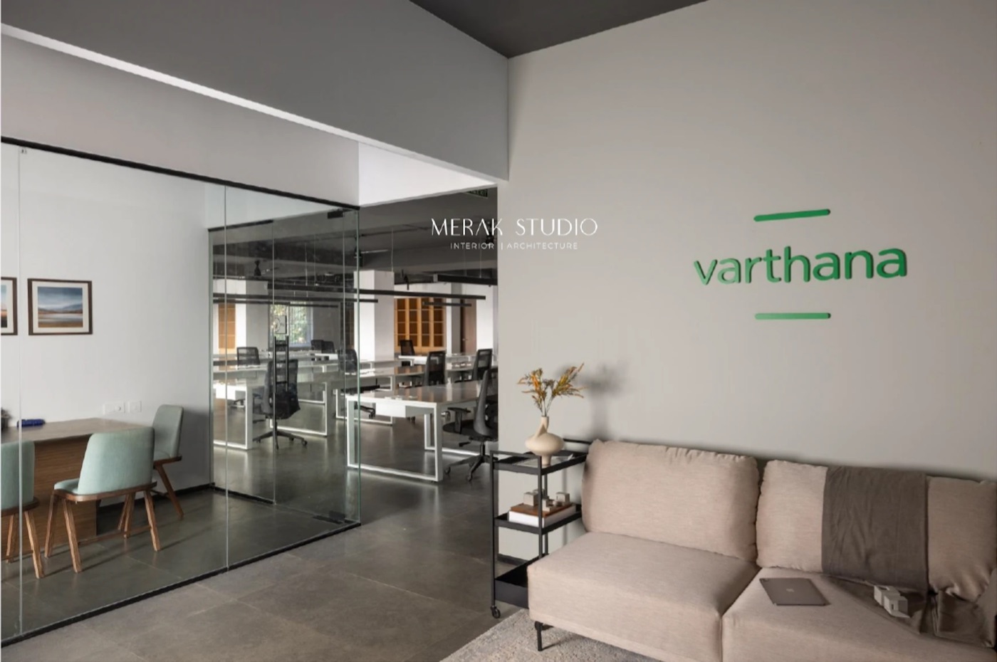 Varthana office, waiting lounge with the brand wall and glass-walled workspace